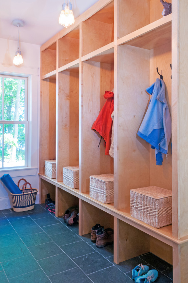 Inspiration for a transitional light wood floor and black floor mudroom remodel with white walls