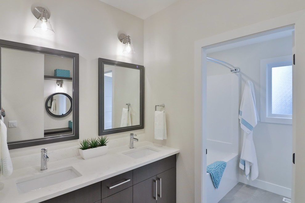 Alcove bathtub - large transitional kids' white tile and porcelain tile vinyl floor and gray floor alcove bathtub idea with flat-panel cabinets, gray cabinets, a two-piece toilet, gray walls, an undermount sink and quartz countertops