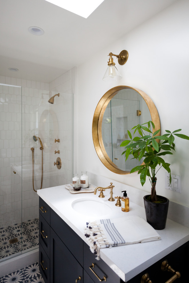 Inspiration for a mid-sized beach style bathroom in Los Angeles with recessed-panel cabinets, black cabinets, marble benchtops, an alcove shower, multi-coloured tile, mosaic tile, white walls, mosaic tile floors and an undermount sink.