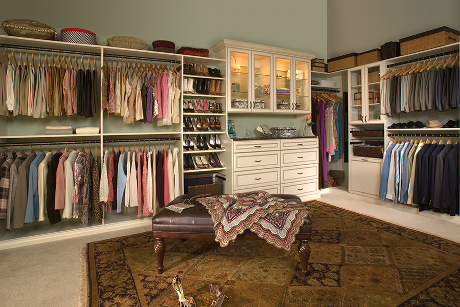 Design ideas for a mid-sized traditional women's walk-in wardrobe in Other with white cabinets.