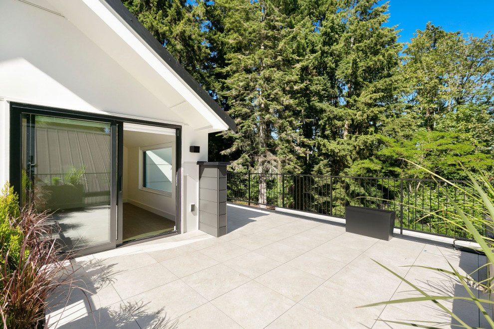 Example of a huge metal railing balcony design in Seattle with no cover