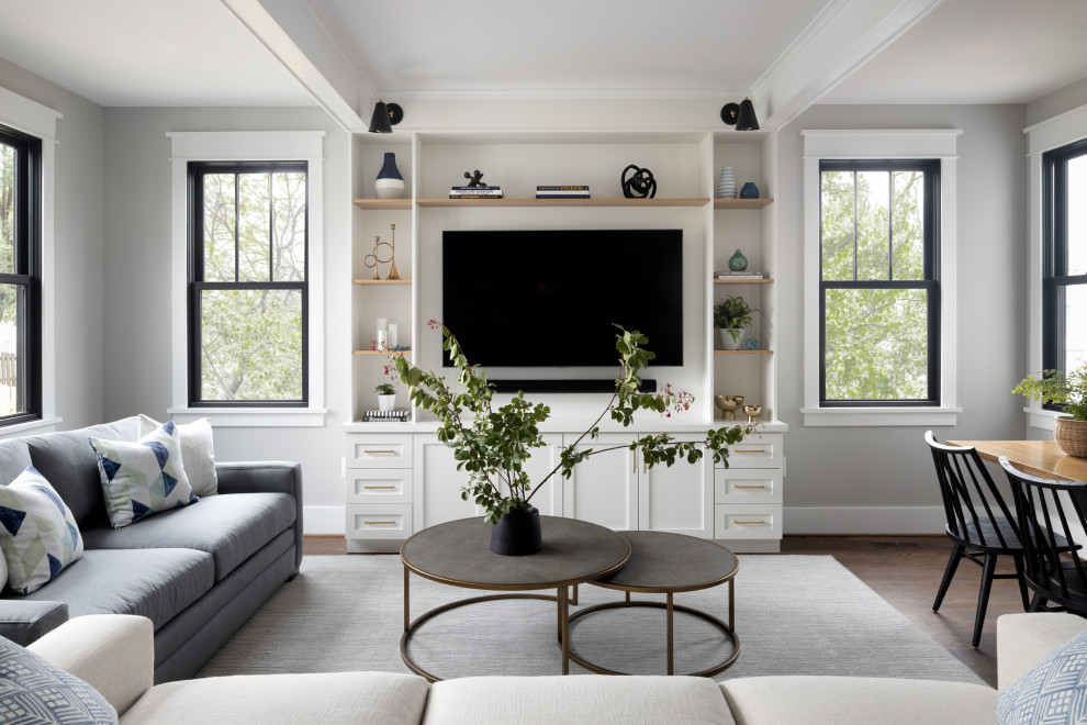 Example of a transitional open concept dark wood floor and brown floor family room design in DC Metro with gray walls and a media wall