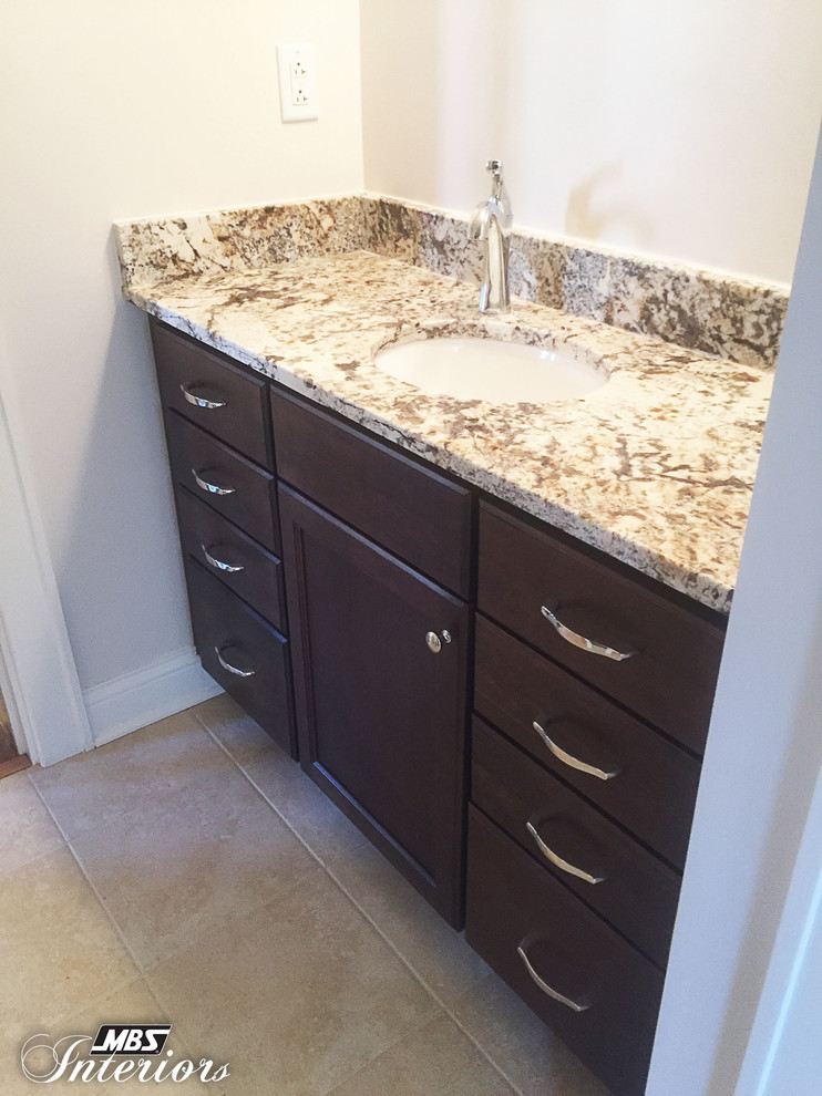 Inspiration for a large transitional medium tone wood floor bathroom remodel in Cincinnati with recessed-panel cabinets and dark wood cabinets