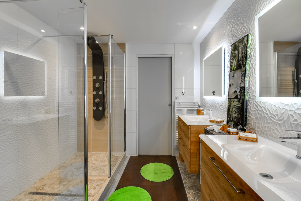 This is an example of a large master bathroom in Toulouse with beaded inset cabinets, light wood cabinets, a curbless shower, white tile, ceramic tile, white walls, mosaic tile floors, a trough sink, laminate benchtops, brown floor, an open shower and white benchtops.
