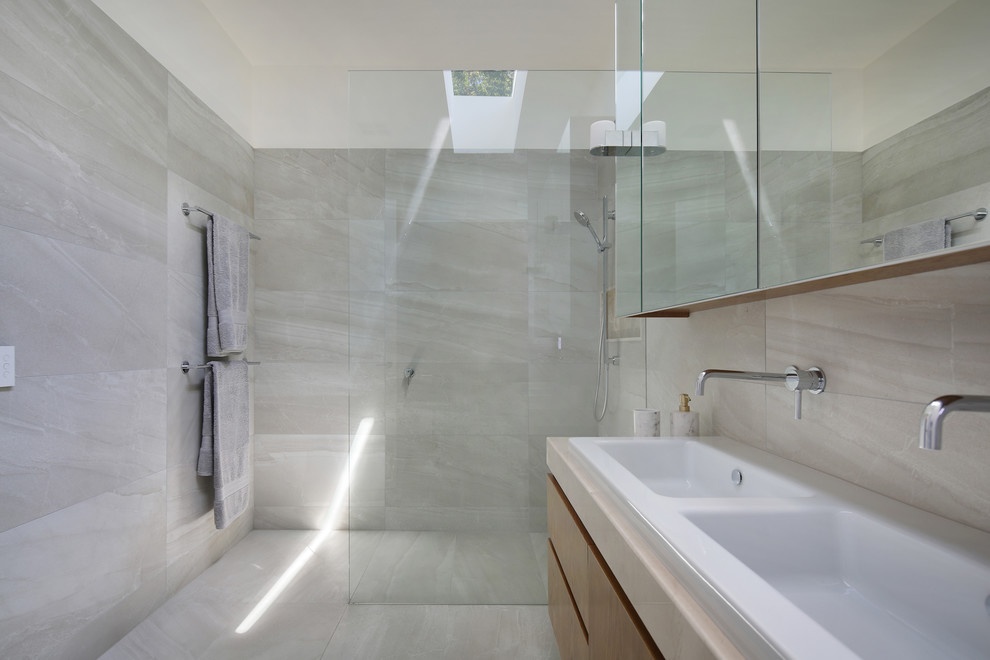 Photo of a large contemporary bathroom in Melbourne with raised-panel cabinets, beige cabinets, an open shower, a two-piece toilet, beige tile, ceramic tile, beige walls, ceramic floors, a drop-in sink, engineered quartz benchtops, beige floor and an open shower.