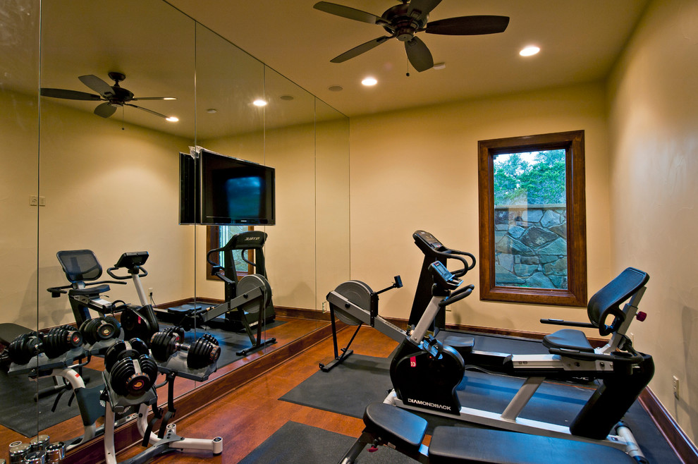 Expansive traditional multipurpose gym in Austin with beige walls and medium hardwood floors.