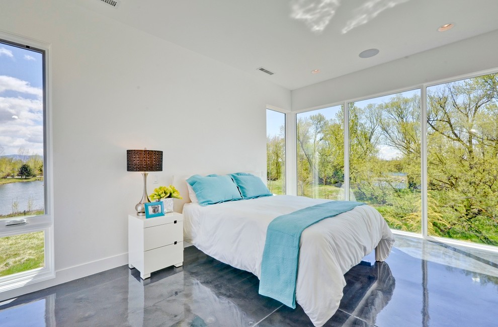 This is an example of a contemporary bedroom in Boise with concrete floors.