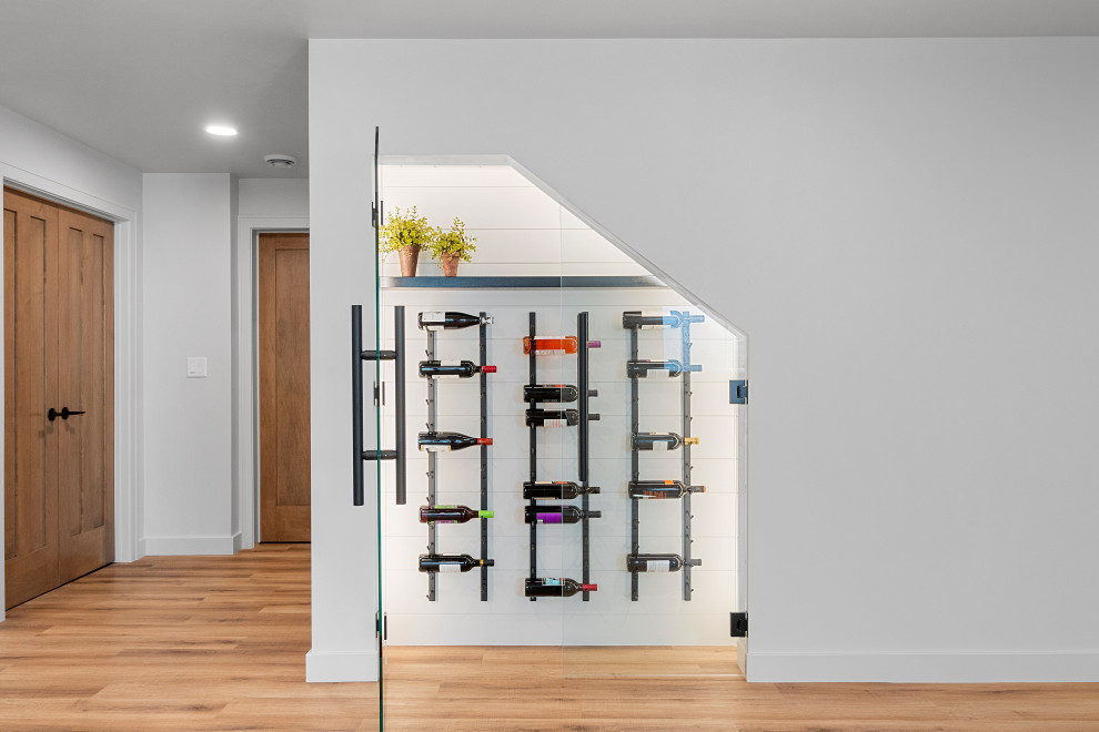 Inspiration for a mid-sized transitional vinyl floor and brown floor wine cellar remodel with display racks