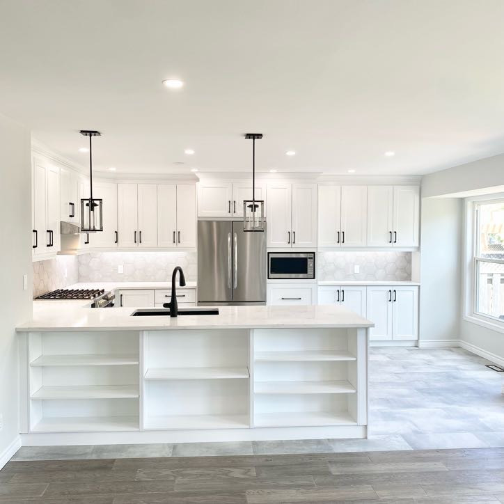 Inspiration for a large classic u-shaped open plan kitchen in Other with a submerged sink, recessed-panel cabinets, white cabinets, quartz worktops, grey splashback, stainless steel appliances, porcelain flooring, a breakfast bar, grey floors and white worktops.