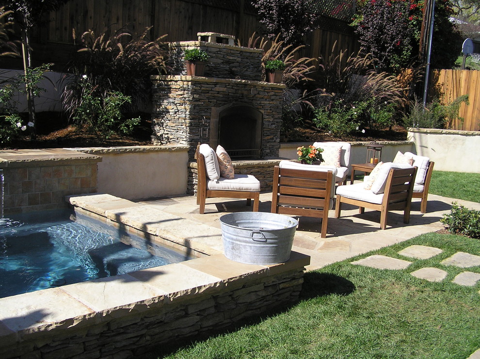 Design ideas for a mid-sized transitional backyard patio in Santa Barbara with a fire feature, natural stone pavers and no cover.