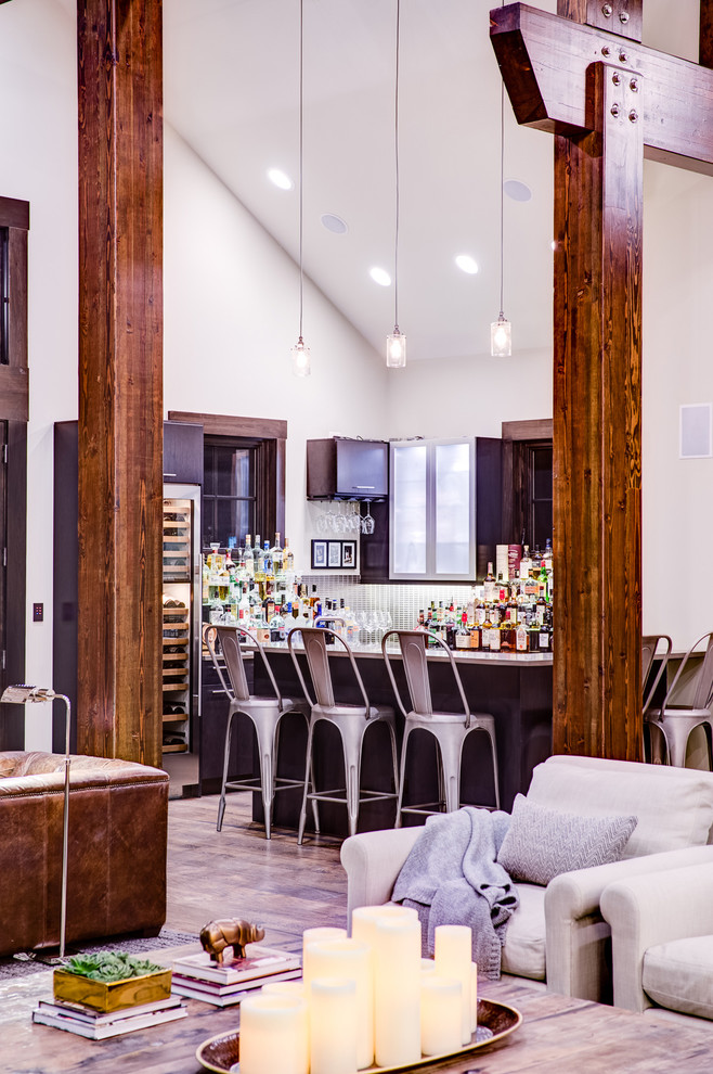 Photo of a large transitional u-shaped seated home bar in Chicago with an undermount sink, flat-panel cabinets, dark wood cabinets, quartz benchtops, green splashback, glass tile splashback and medium hardwood floors.