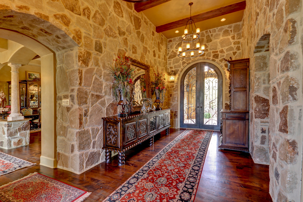 Mediterranean foyer in Austin with dark hardwood floors, a double front door and a glass front door.