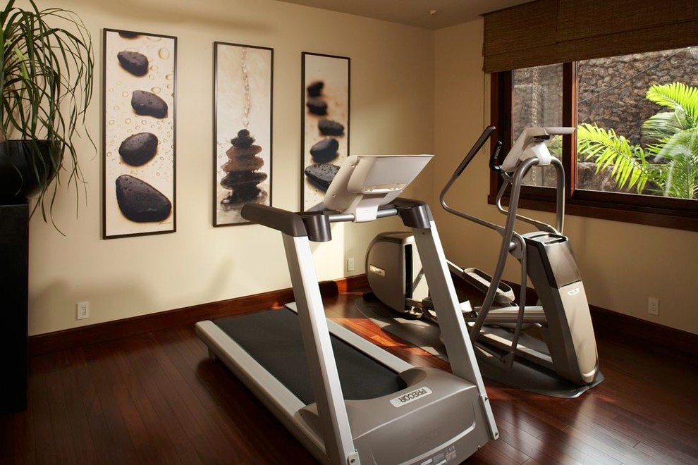 Design ideas for a tropical home gym in Hawaii with beige walls and dark hardwood floors.
