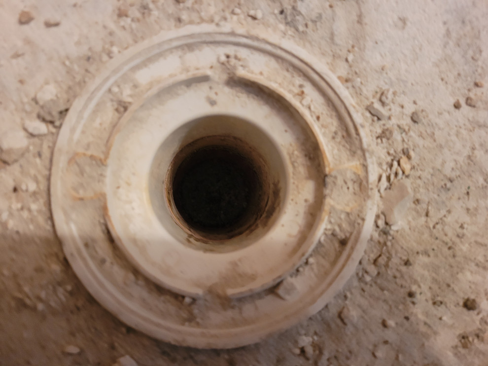 Tie into existing drain in concrete slab for Kerdi shower install.