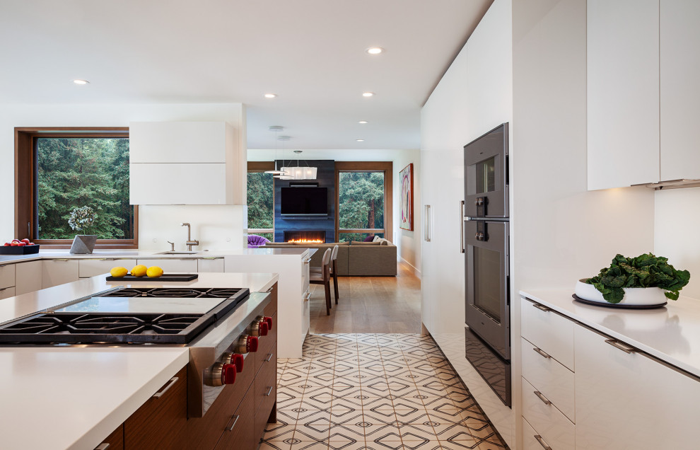 Design ideas for a large midcentury u-shaped open plan kitchen in San Francisco with an undermount sink, flat-panel cabinets, white cabinets, quartzite benchtops, panelled appliances, cement tiles, with island, multi-coloured floor and white benchtop.