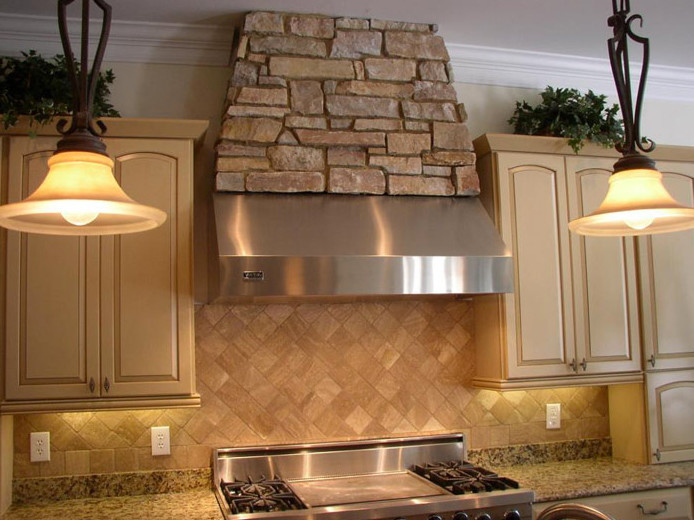 Example of a medium tone wood floor kitchen design in Raleigh with a drop-in sink, raised-panel cabinets, light wood cabinets, granite countertops, beige backsplash, stone tile backsplash and white appliances