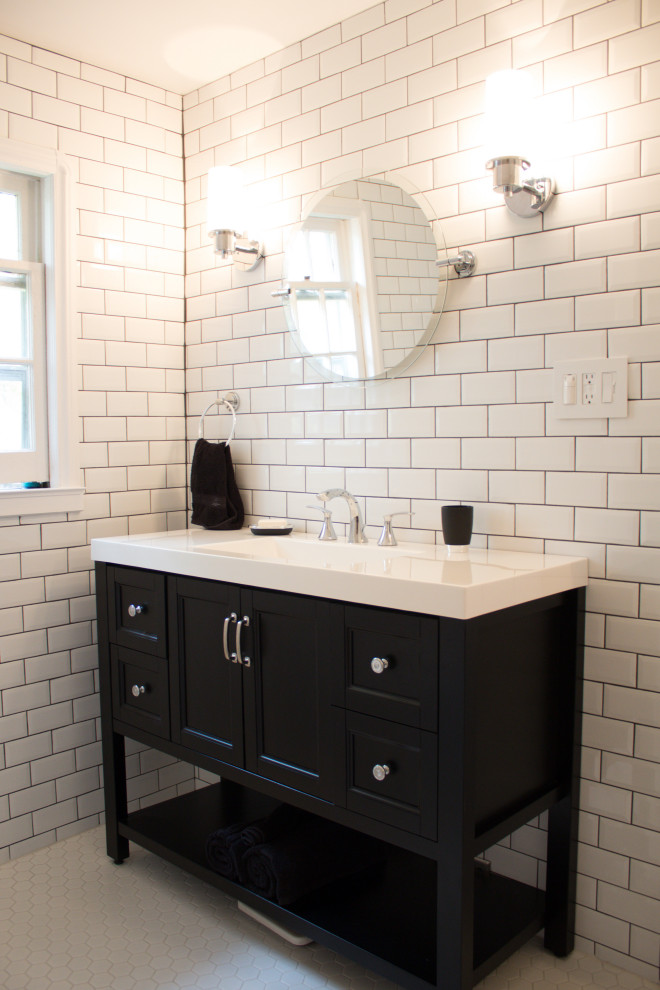 Inspiration for a mid-sized transitional 3/4 bathroom in Toronto with furniture-like cabinets, black cabinets, an alcove tub, an alcove shower, a one-piece toilet, white tile, subway tile, white walls, ceramic floors, solid surface benchtops, white floor, a shower curtain and white benchtops.