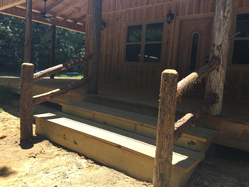 Inspiration for a large rustic front porch remodel with decking and a roof extension