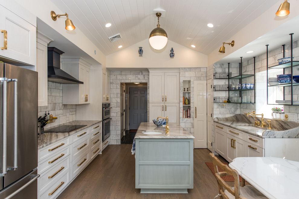 Photo of a large eclectic u-shaped open plan kitchen in DC Metro with an undermount sink, recessed-panel cabinets, white cabinets, marble benchtops, subway tile splashback, stainless steel appliances, medium hardwood floors, with island and grey splashback.