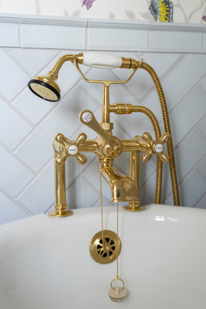 Elegant blue tile and ceramic tile single-sink claw-foot bathtub photo in Cincinnati with quartz countertops, white countertops and a freestanding vanity