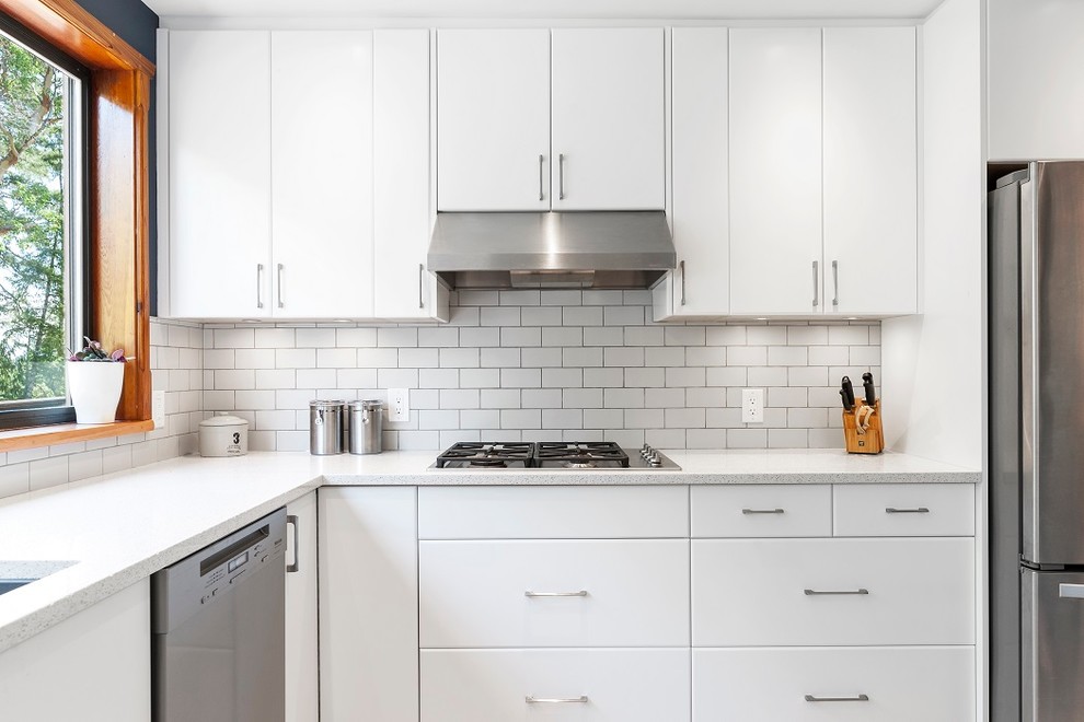 Inspiration for a mid-sized scandinavian u-shaped open plan kitchen in Other with an undermount sink, flat-panel cabinets, white cabinets, quartz benchtops, white splashback, subway tile splashback, stainless steel appliances, porcelain floors, a peninsula and white benchtop.