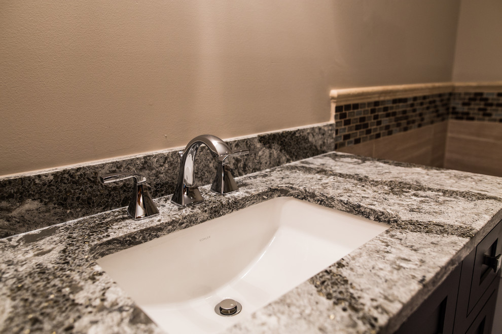 Mid-sized transitional master porcelain tile home design photo in Chicago with black cabinets, brown walls, an undermount sink and granite countertops