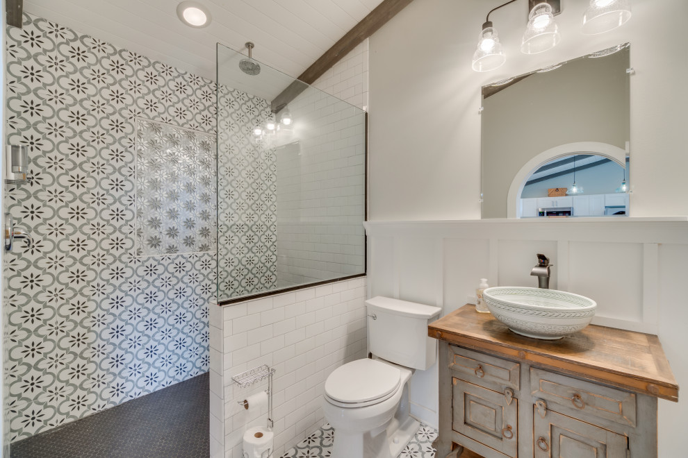 Inspiration for a mid-sized eclectic bathroom in DC Metro with raised-panel cabinets, grey cabinets, an open shower, white tile, ceramic tile, grey walls, porcelain floors, a vessel sink, wood benchtops, grey floor, an open shower, a single vanity, a freestanding vanity, timber and decorative wall panelling.