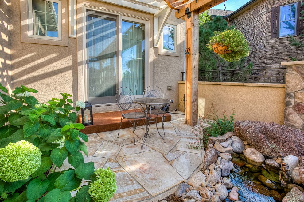Design ideas for a mid-sized transitional partial sun front yard stone walkway in Denver.
