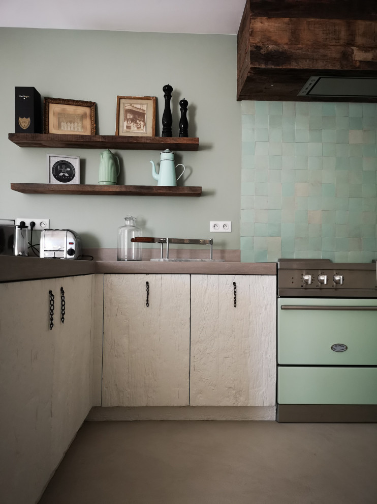 Inspiration for a mid-sized country u-shaped eat-in kitchen in Other with an undermount sink, beaded inset cabinets, white cabinets, concrete benchtops, green splashback, ceramic splashback, coloured appliances, concrete floors, multiple islands, grey floor and grey benchtop.