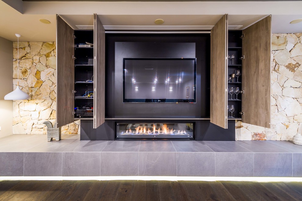 Photo of a large modern formal enclosed living room in Melbourne with white walls, dark hardwood floors, a ribbon fireplace, a tile fireplace surround, a concealed tv and brown floor.