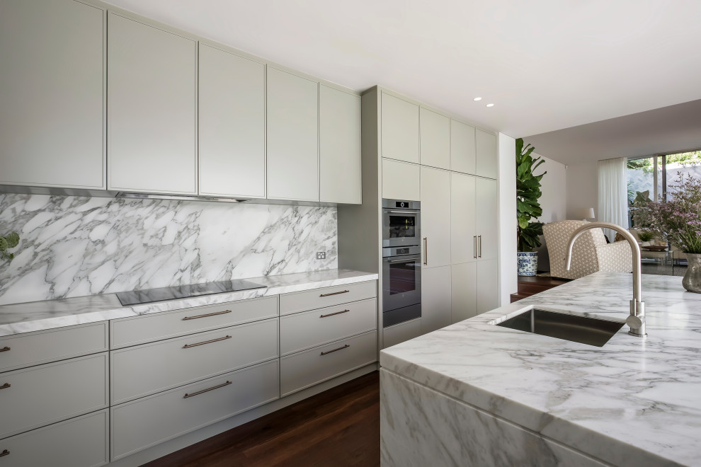Photo of a large contemporary galley eat-in kitchen in Sydney with an undermount sink, shaker cabinets, green cabinets, marble benchtops, white splashback, marble splashback, stainless steel appliances, dark hardwood floors, with island, brown floor and white benchtop.