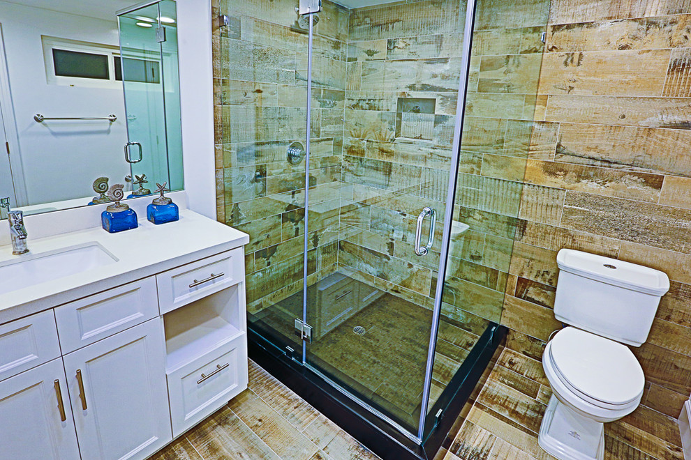 Design ideas for a small traditional 3/4 bathroom in Los Angeles with furniture-like cabinets, white cabinets, an alcove shower, a one-piece toilet, ceramic tile, grey walls, ceramic floors, an undermount sink, concrete benchtops, multi-coloured floor, a hinged shower door, white benchtops, a freestanding tub and brown tile.