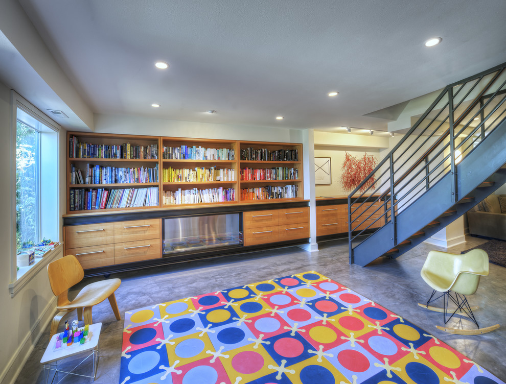 This is an example of a midcentury family room in Seattle with concrete floors.