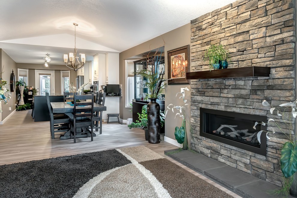 Mid-sized modern open concept living room in Vancouver with beige walls, light hardwood floors, a ribbon fireplace and a stone fireplace surround.