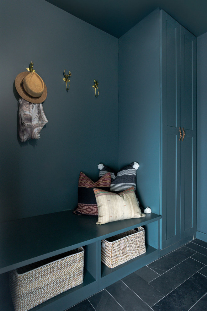 Design ideas for a mid-sized transitional mudroom in San Francisco with blue walls, slate floors, a single front door and black floor.