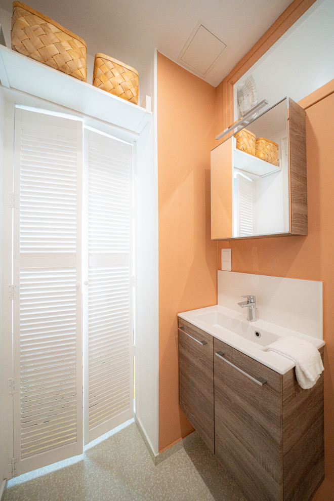 Inspiration för små klassiska vitt badrum med dusch, med släta luckor, bruna skåp, en dusch i en alkov, en toalettstol med hel cisternkåpa, vit kakel, keramikplattor, orange väggar, terrazzogolv, ett undermonterad handfat, beiget golv och dusch med gångjärnsdörr