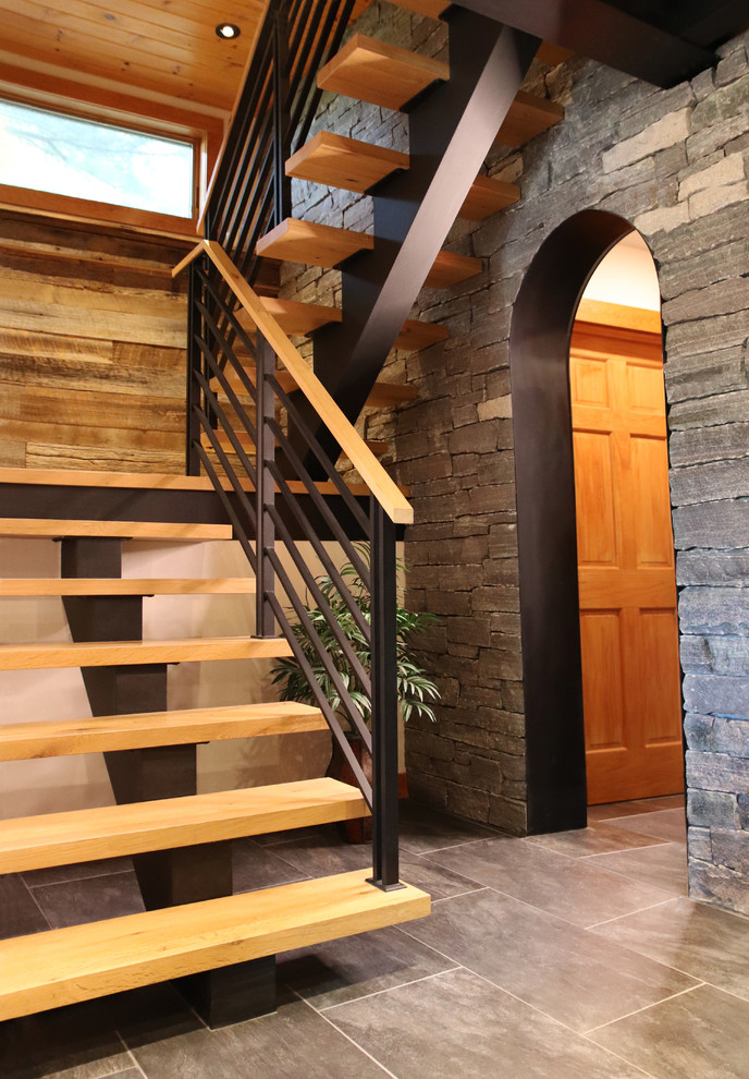 Design ideas for a mid-sized country wood floating staircase in New York with open risers and metal railing.