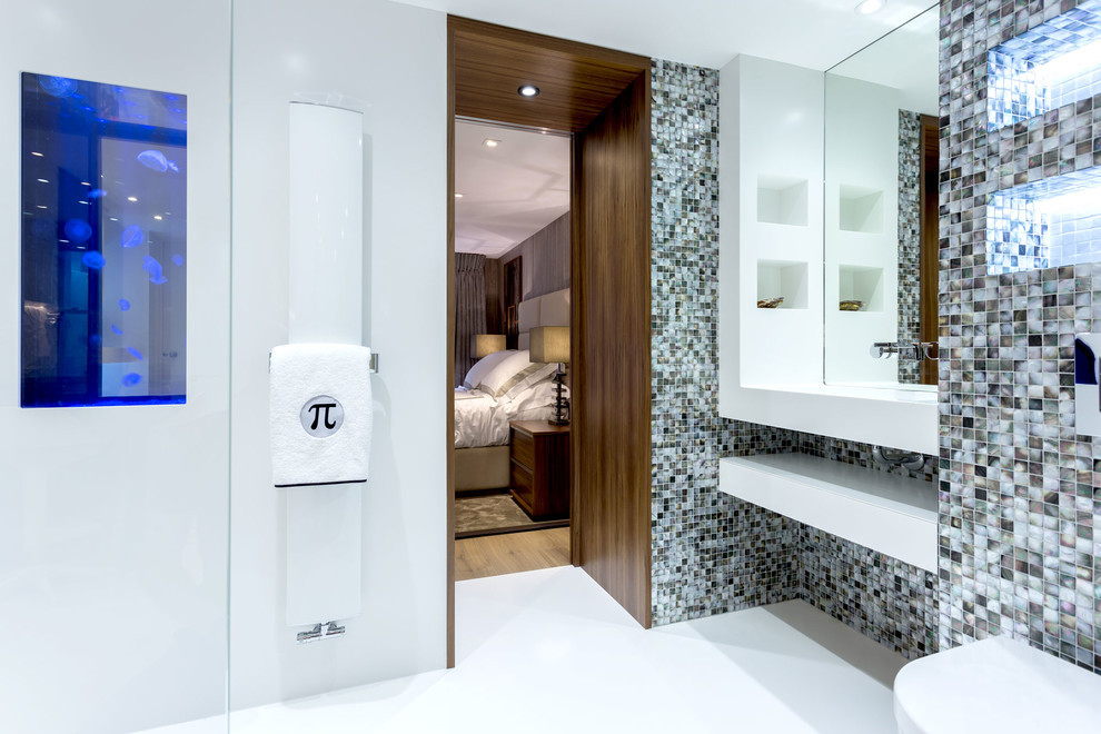 Photo of a small contemporary 3/4 bathroom in London with an open shower, a wall-mount toilet, multi-coloured tile, mosaic tile and white walls.