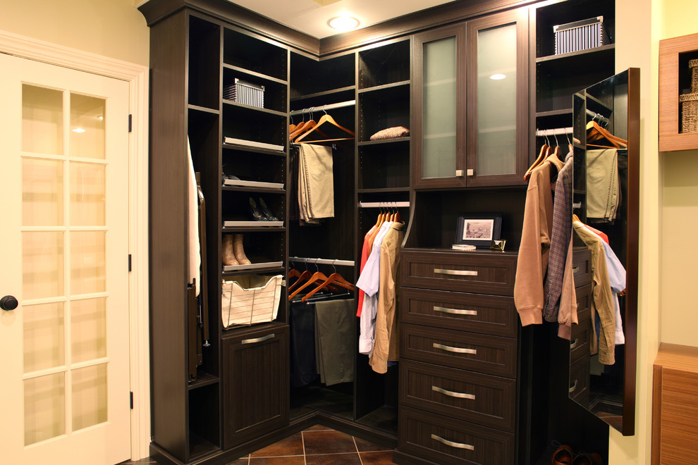 Inspiration for a small contemporary walk-in wardrobe in New York with recessed-panel cabinets, dark wood cabinets and porcelain floors.
