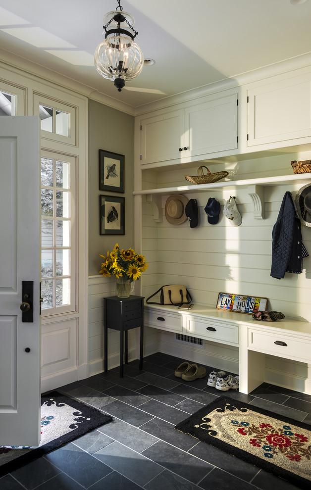Traditional mudroom in New York with black floor.