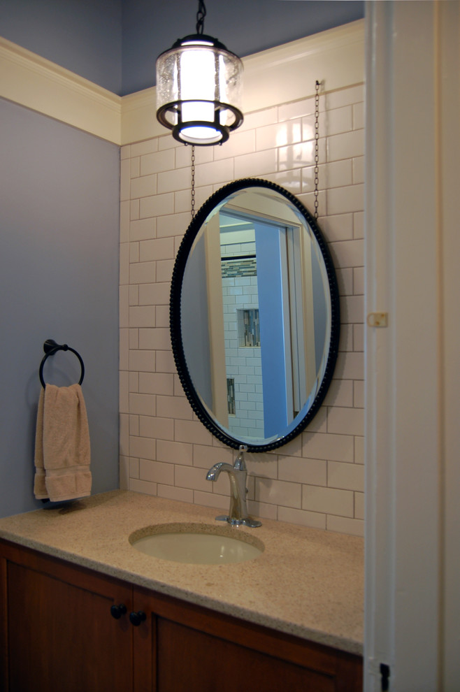 This is an example of a small traditional 3/4 bathroom in Louisville with an undermount sink, shaker cabinets, medium wood cabinets, white tile, subway tile and blue walls.