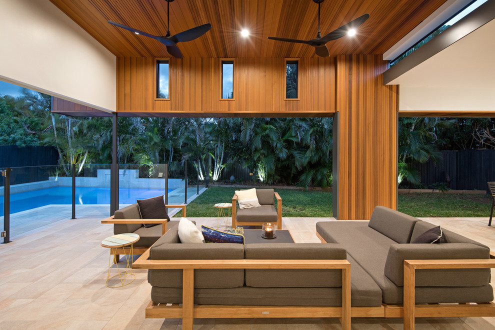This is an example of a mid-sized contemporary backyard patio in Brisbane with tile and a roof extension.