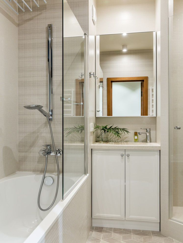 Design ideas for a contemporary master bathroom in Moscow with recessed-panel cabinets, white cabinets, an alcove tub, an alcove shower, beige tile, beige floor, a hinged shower door and beige benchtops.