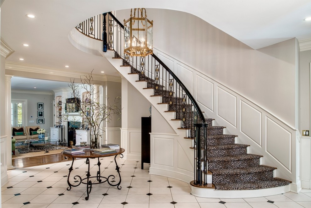This is an example of a traditional foyer in New York with grey walls and marble floors.