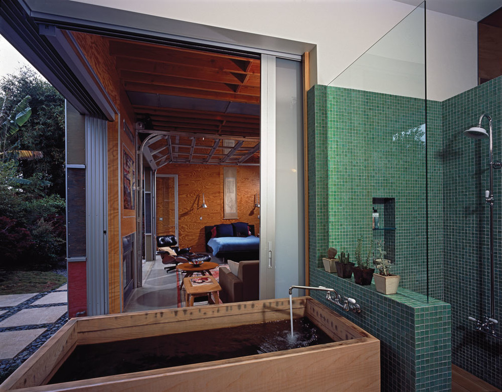 Beach style bathroom in Los Angeles with a japanese tub and green tile.
