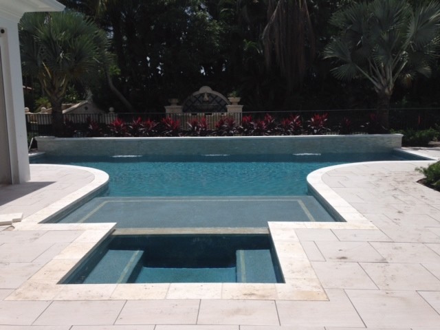 Inspiration for a large backyard custom-shaped natural pool fountain remodel in Miami