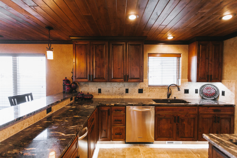 Inspiration for a transitional kitchen remodel with dark wood cabinets, granite countertops, beige backsplash, stainless steel appliances and beige walls