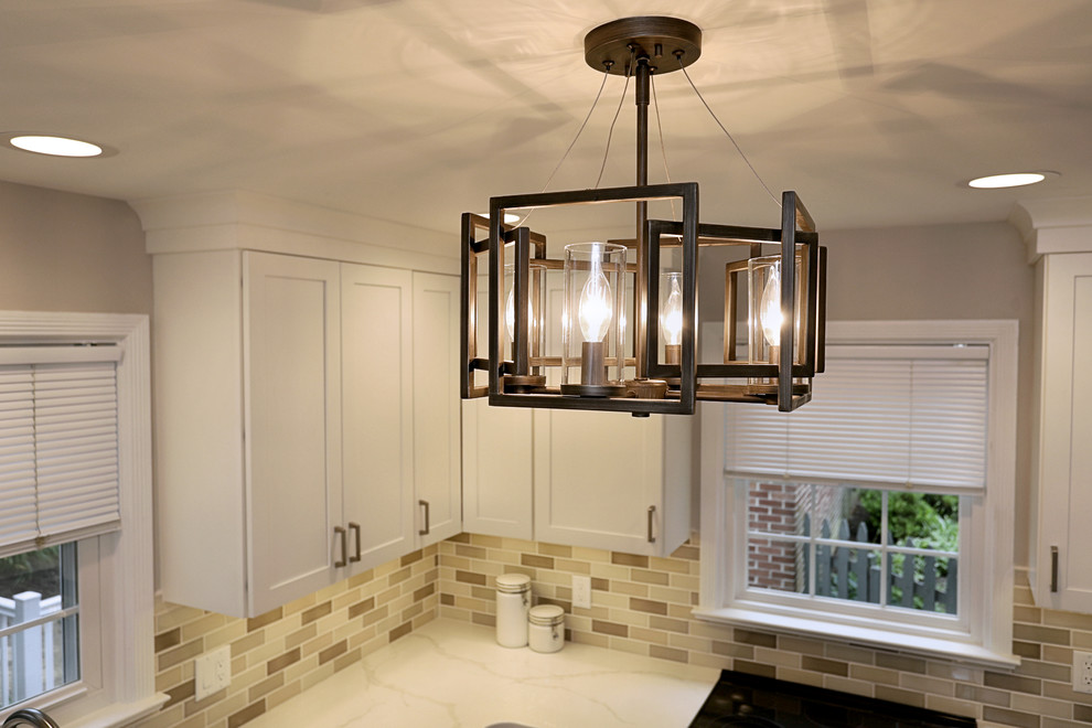 Inspiration for a small transitional ceramic tile and beige floor kitchen remodel with a double-bowl sink, shaker cabinets, quartz countertops, beige backsplash, ceramic backsplash, stainless steel appliances and white countertops