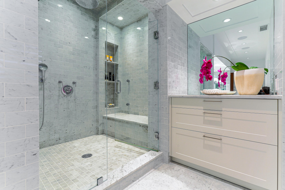 Photo of a large contemporary bathroom in New York with shaker cabinets, white cabinets, an alcove shower, gray tile, a vessel sink, grey floor, a hinged shower door, grey benchtops, a niche and a shower seat.