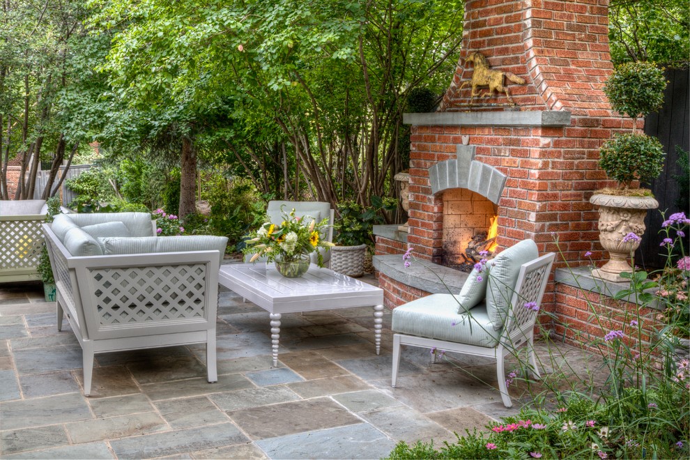 Traditional patio in Denver with with fireplace and no cover.